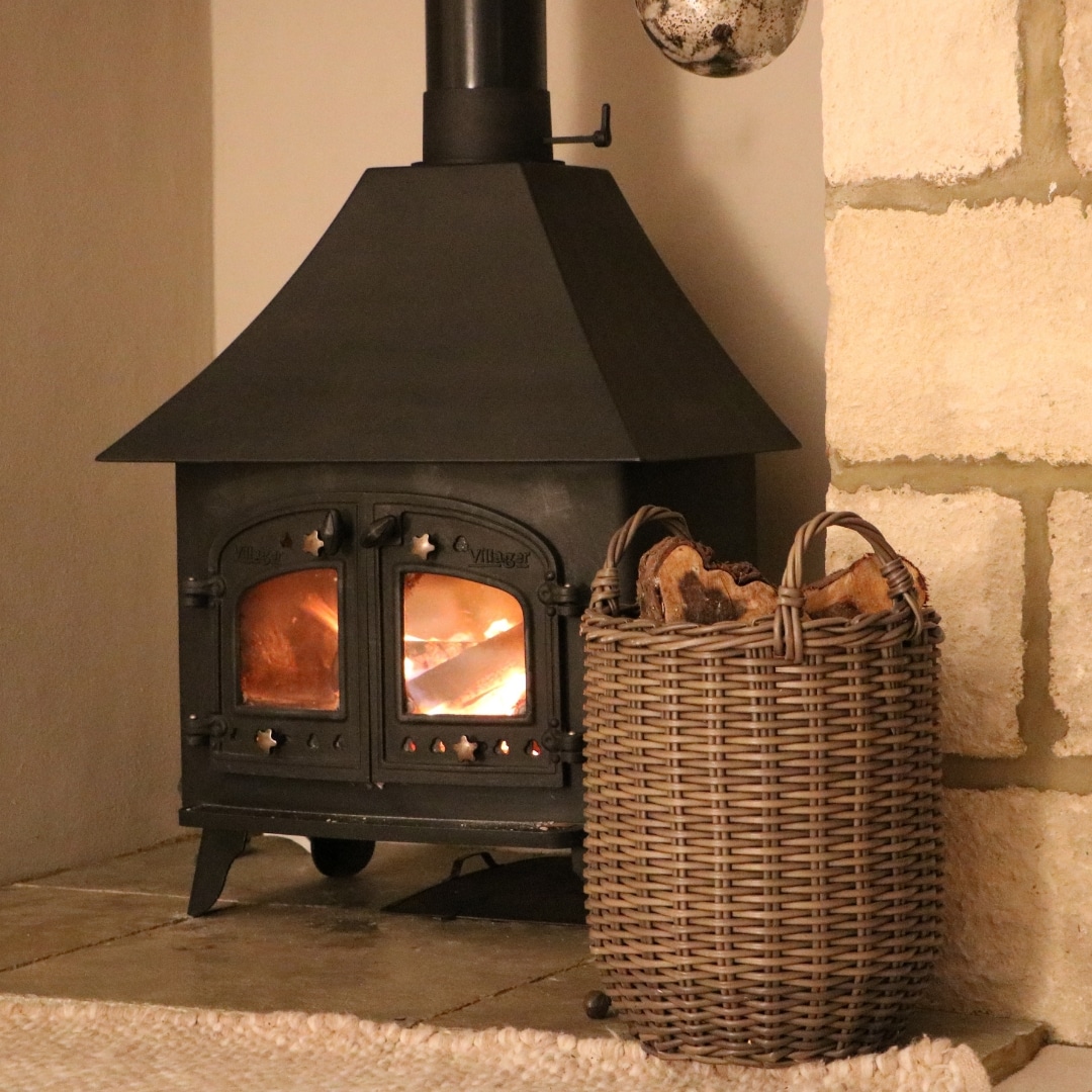 Cozy fire with logs in a wooden basket
