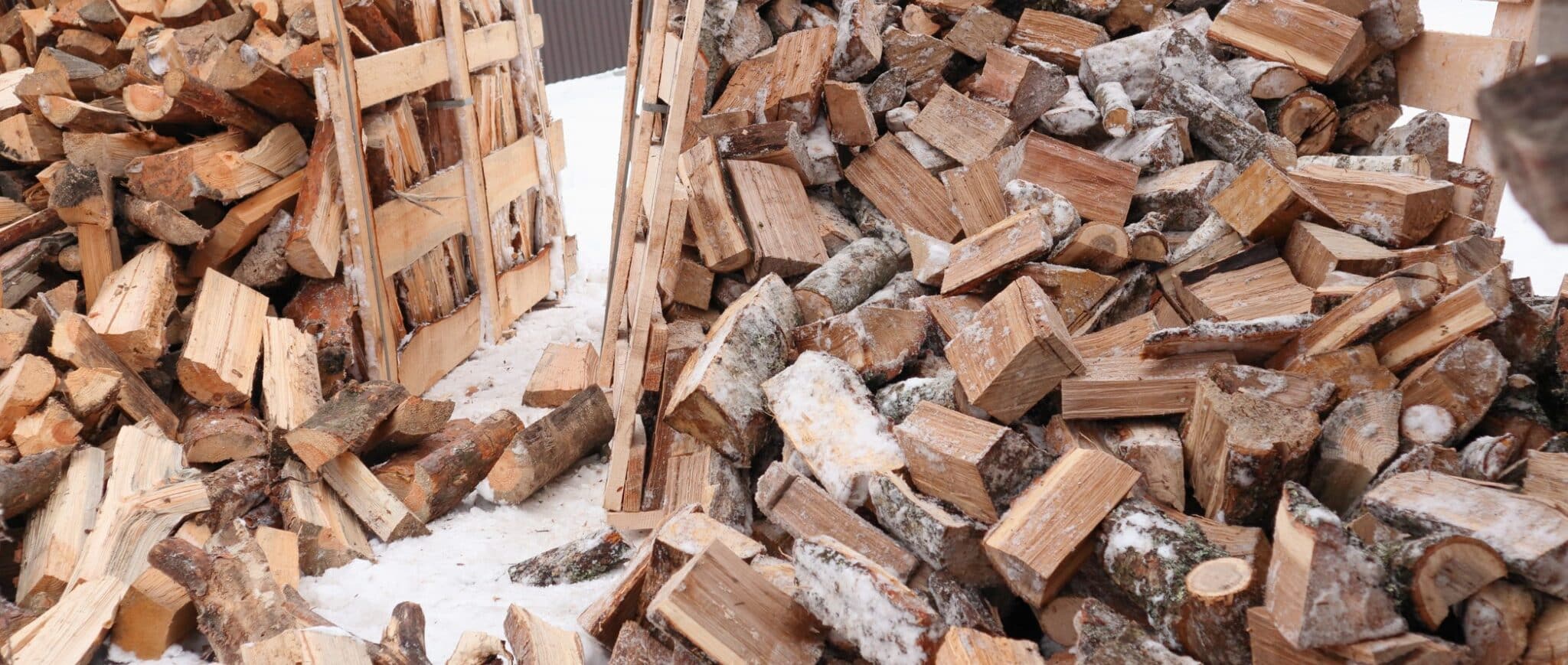 Large pile of Firewood outside in the snow